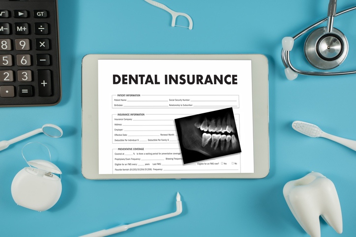 Illustration of a dental insurance form with tools and a tooth model on a blue background.
