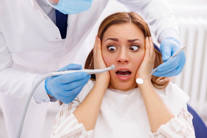 A dentist is preparing sedation for a nervous patient for a smooth dental treatment in Glendale, WI.